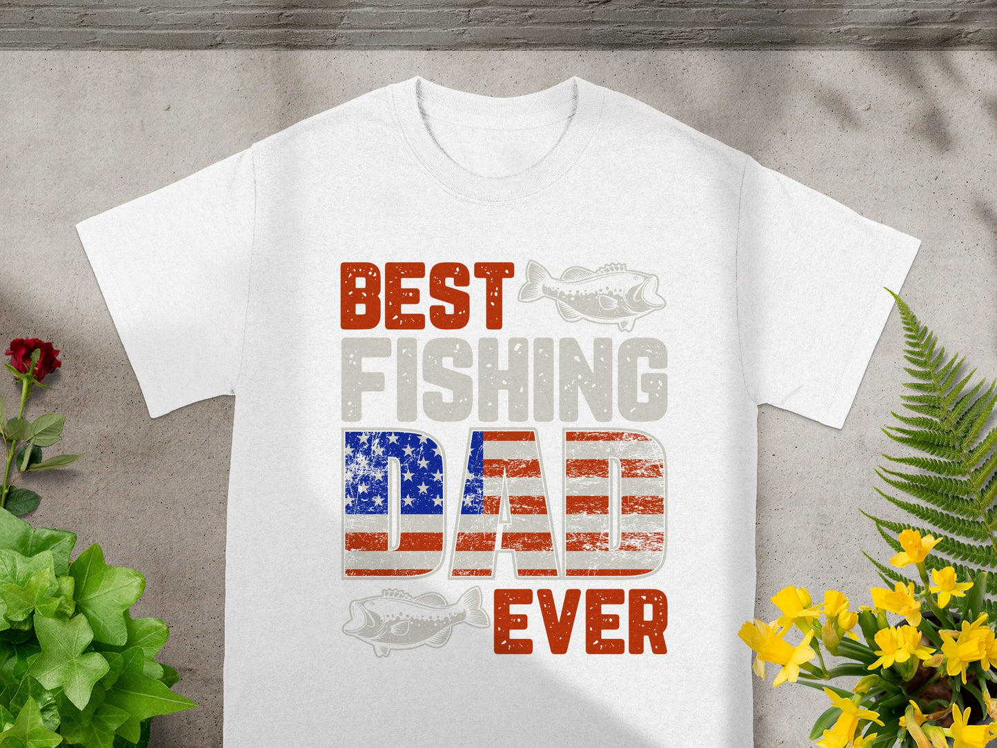 White t-shirt with "BEST FISHING DAD EVER" text featuring American flag detail.