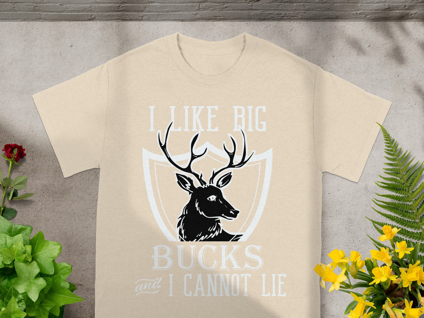 T-shirt with black deer silhouette and text "I LIKE BIG BUCKS and I CANNOT LIE."