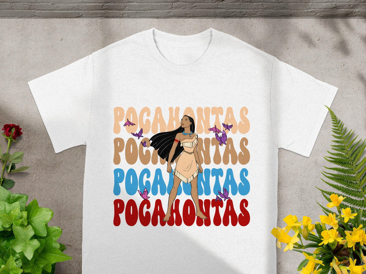 White t-shirt with "Pocahontas" in stylized text and butterfly graphics.