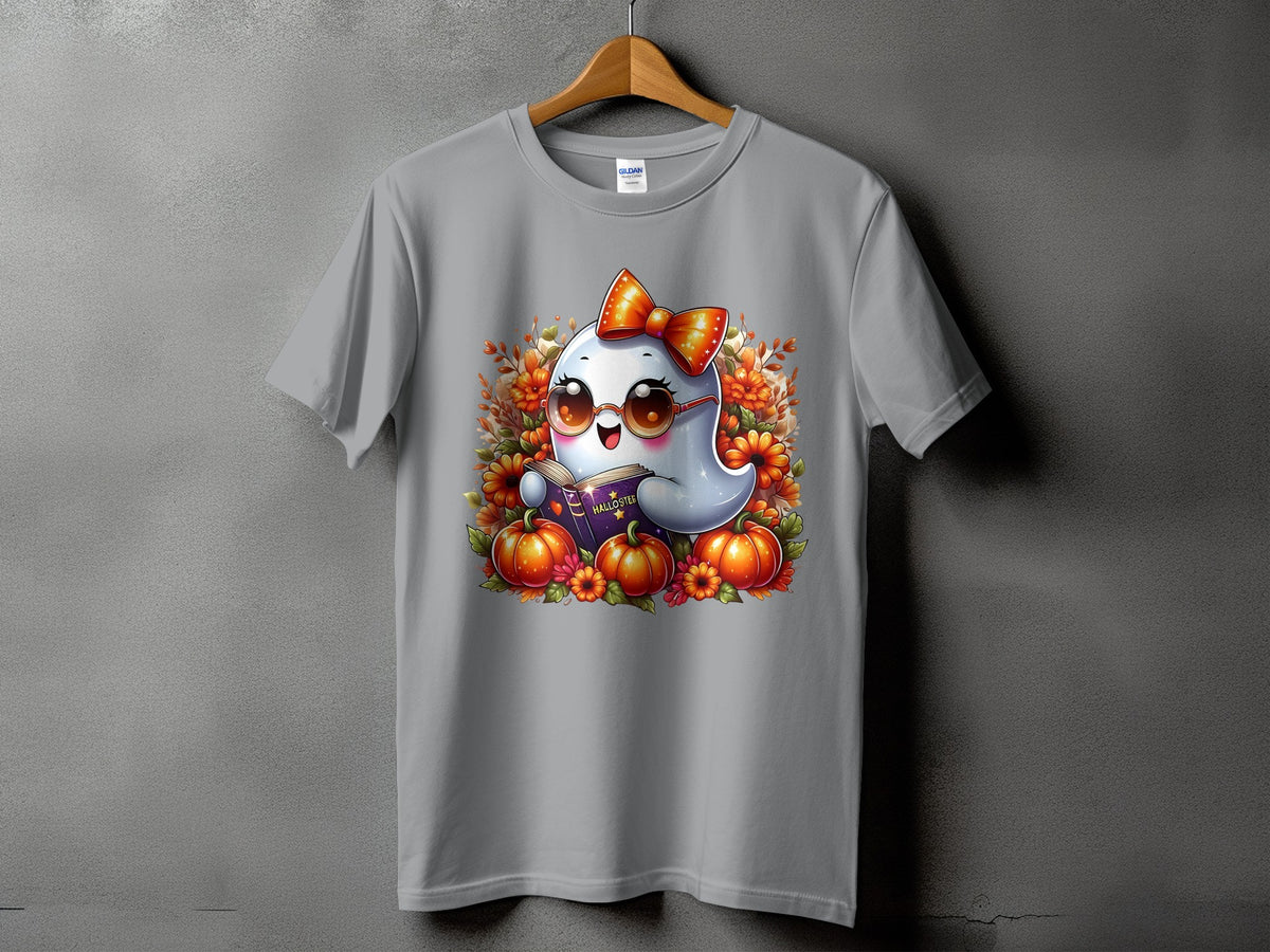Gray t-shirt with a cute ghost reading a book surrounded by pumpkins and fall flowers.