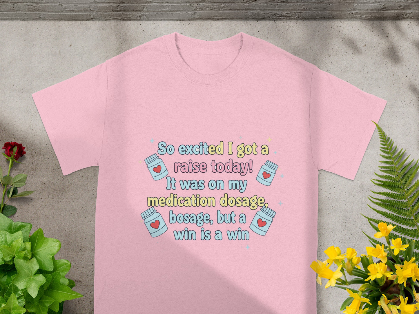 Pink t-shirt with "So excited I got a raise today!" text and medication icons.