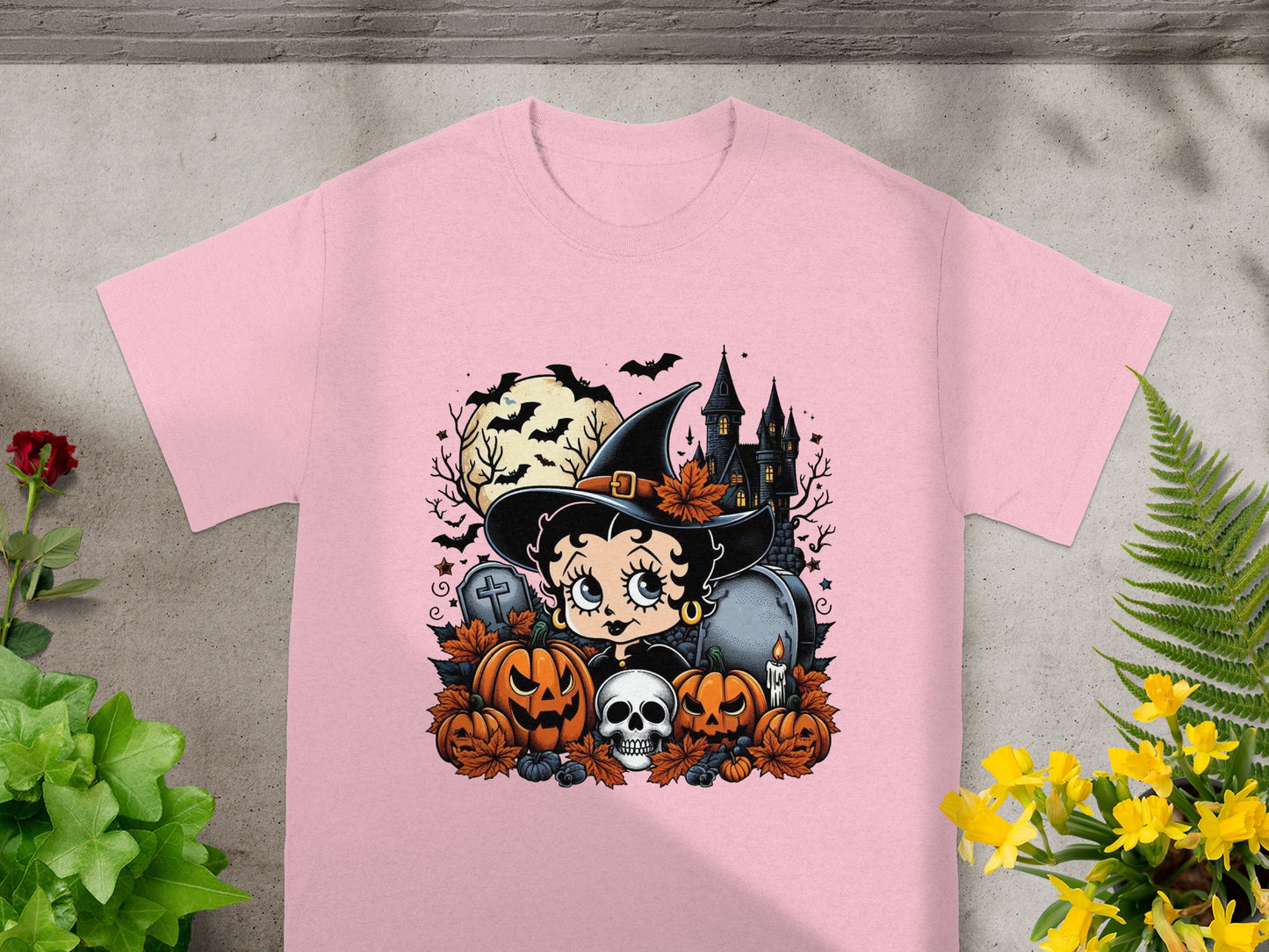 Pink t-shirt with Betty Boop as a witch surrounded by Halloween elements.