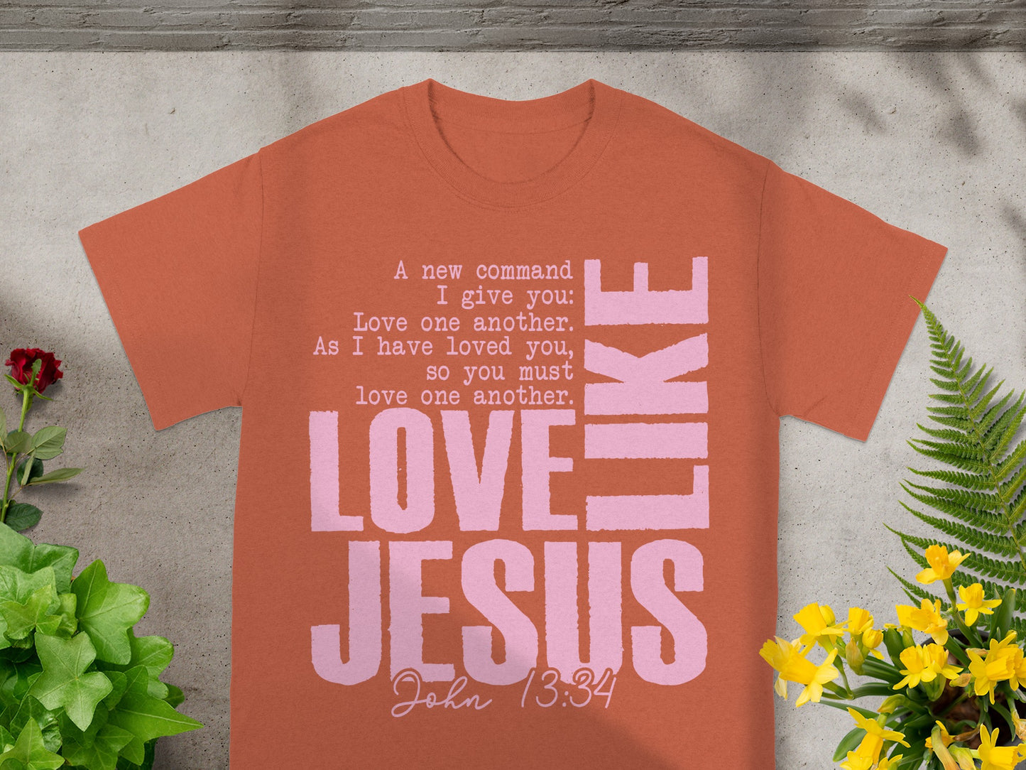 Orange t-shirt with pink text: "LOVE LIKE JESUS John 13:34."