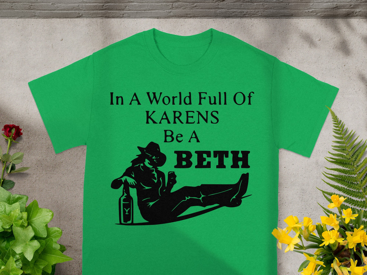 Green t-shirt with "In A World Full Of KARENS Be A BETH" text and graphic.