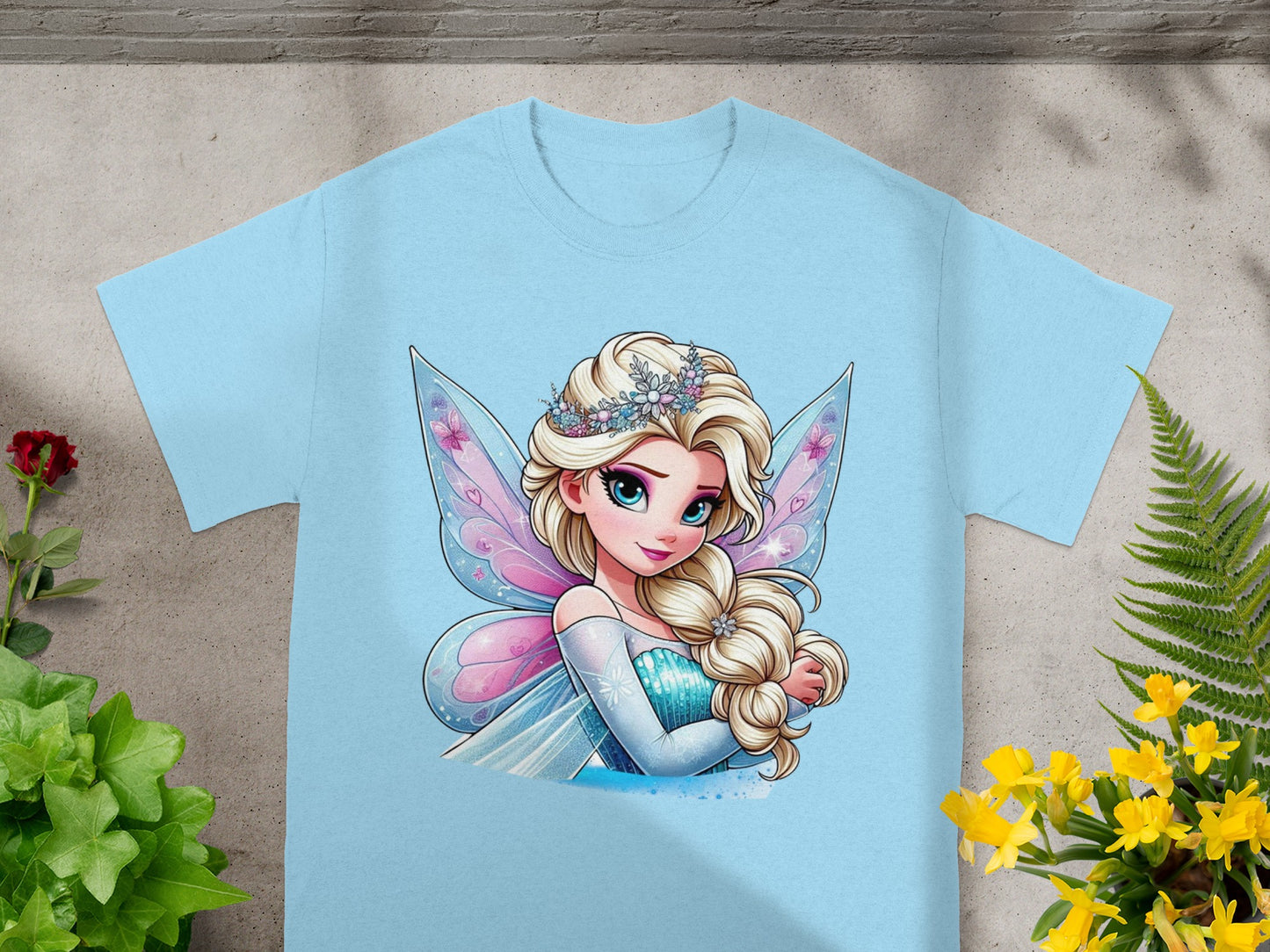 Light blue t-shirt featuring a cartoon princess with blonde hair, fairy wings, and a tiara.
