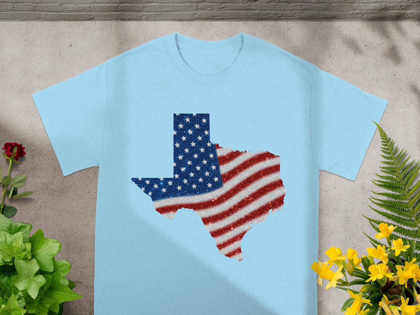 Light blue t-shirt with Texas shape in glittery American flag design.