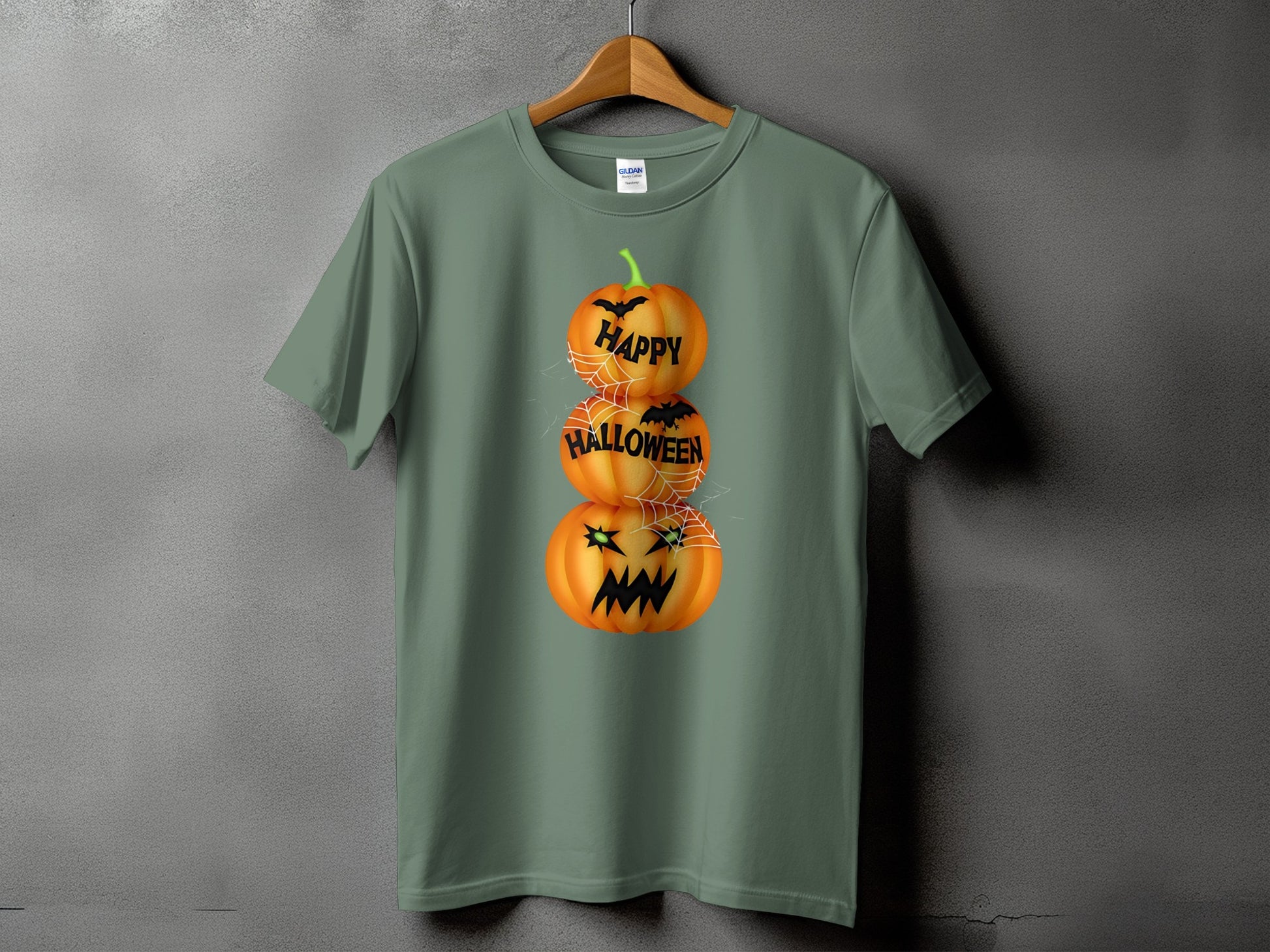 Green t-shirt with stacked pumpkins saying "Happy Halloween" and spiderwebs.