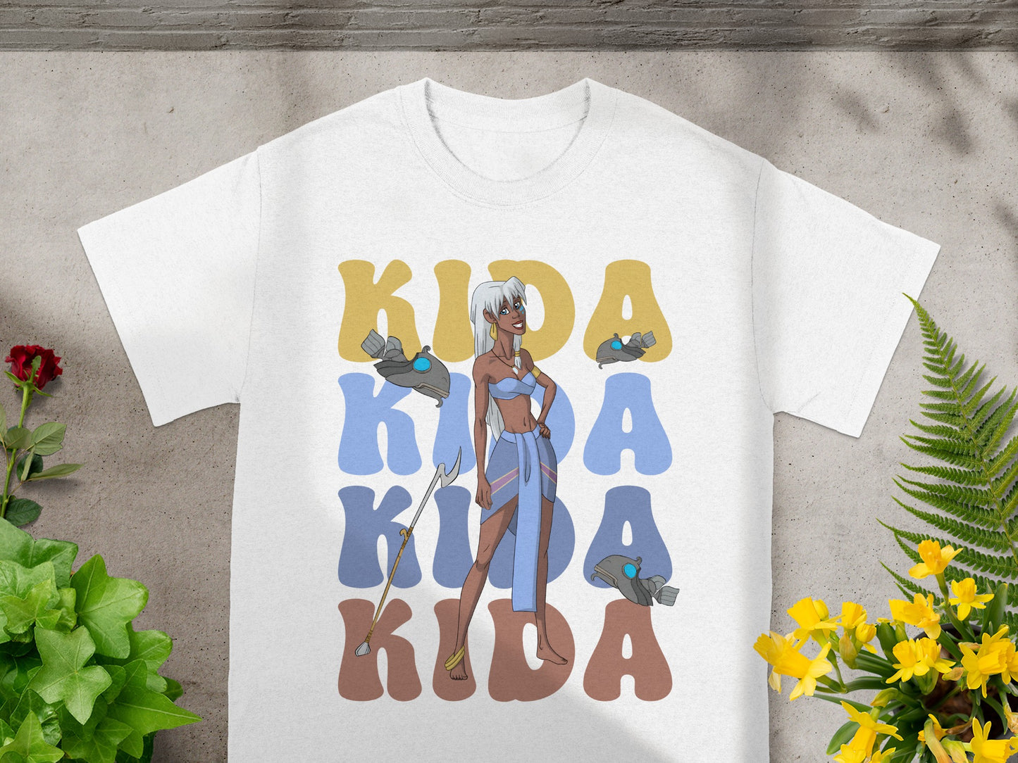 White t-shirt with Kida's name in large blue and yellow text.