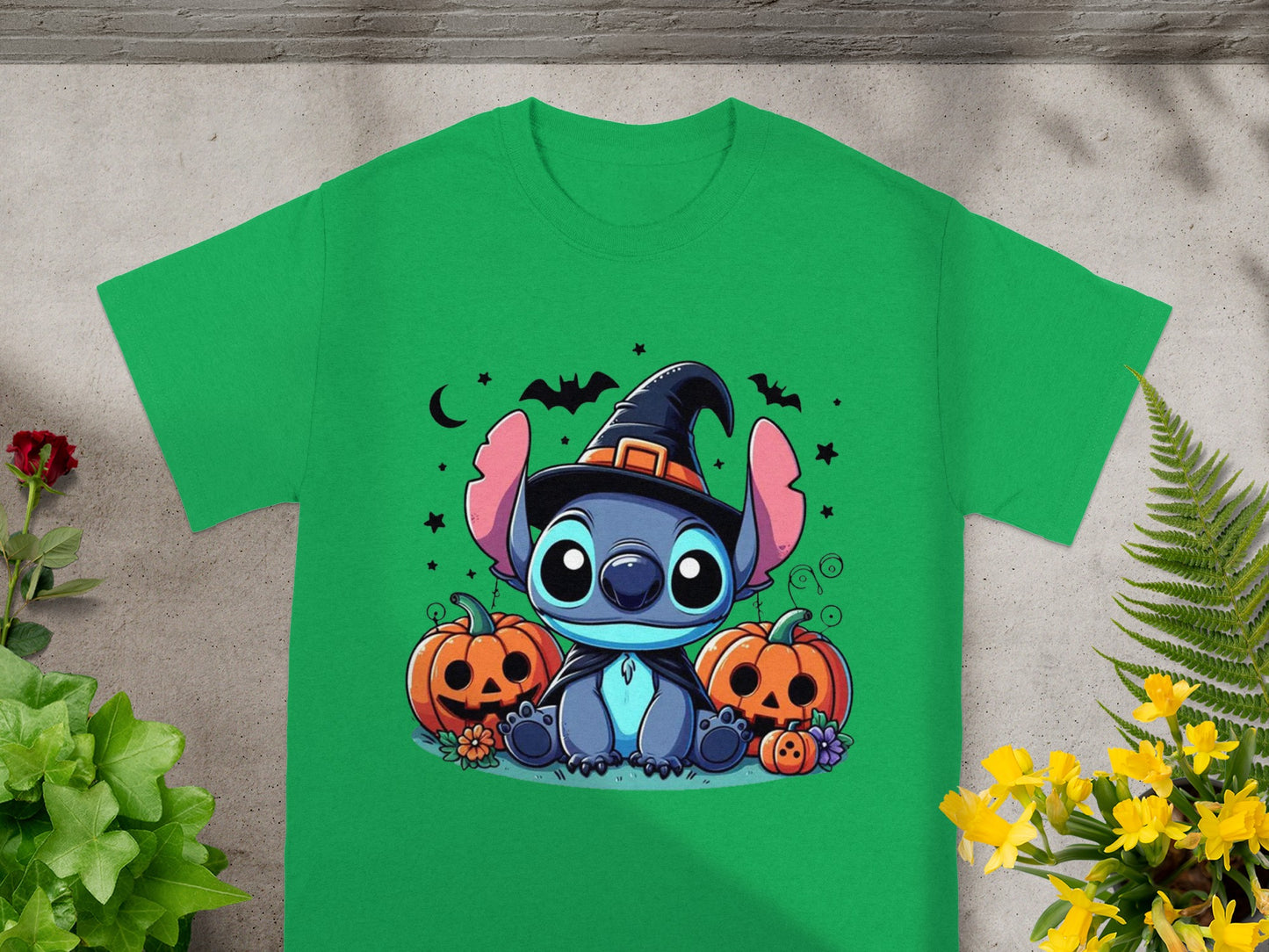 Green t-shirt with Stitch wearing a witch hat and surrounded by pumpkins.