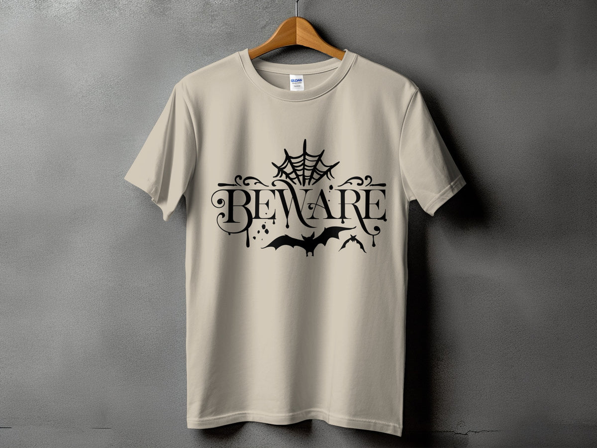 Tan t-shirt with black "BEWARE" text, spiderweb, and bats graphic.