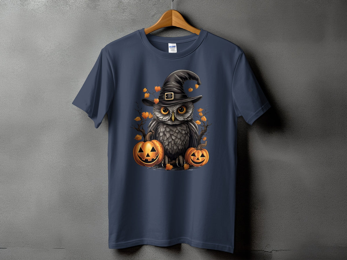 Owl in witch hat with pumpkins and autumn leaves graphic on navy t-shirt.