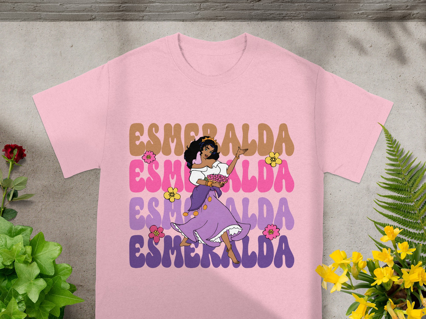 Pink t-shirt with "ESMERALDA" in colorful bubbly letters and a cartoon character.