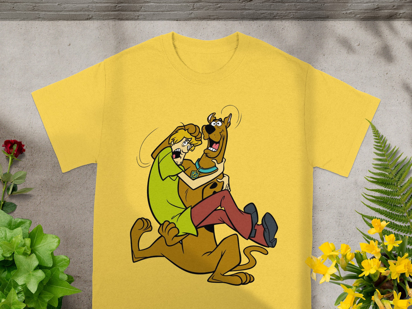 Yellow t-shirt with Scooby-Doo and Shaggy in a playful embrace.