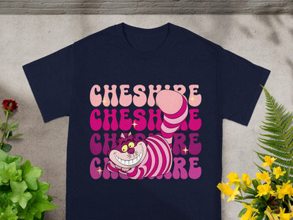 Cheshire Cat smiling with "Cheshire" text in pastel gradient on navy t-shirt.