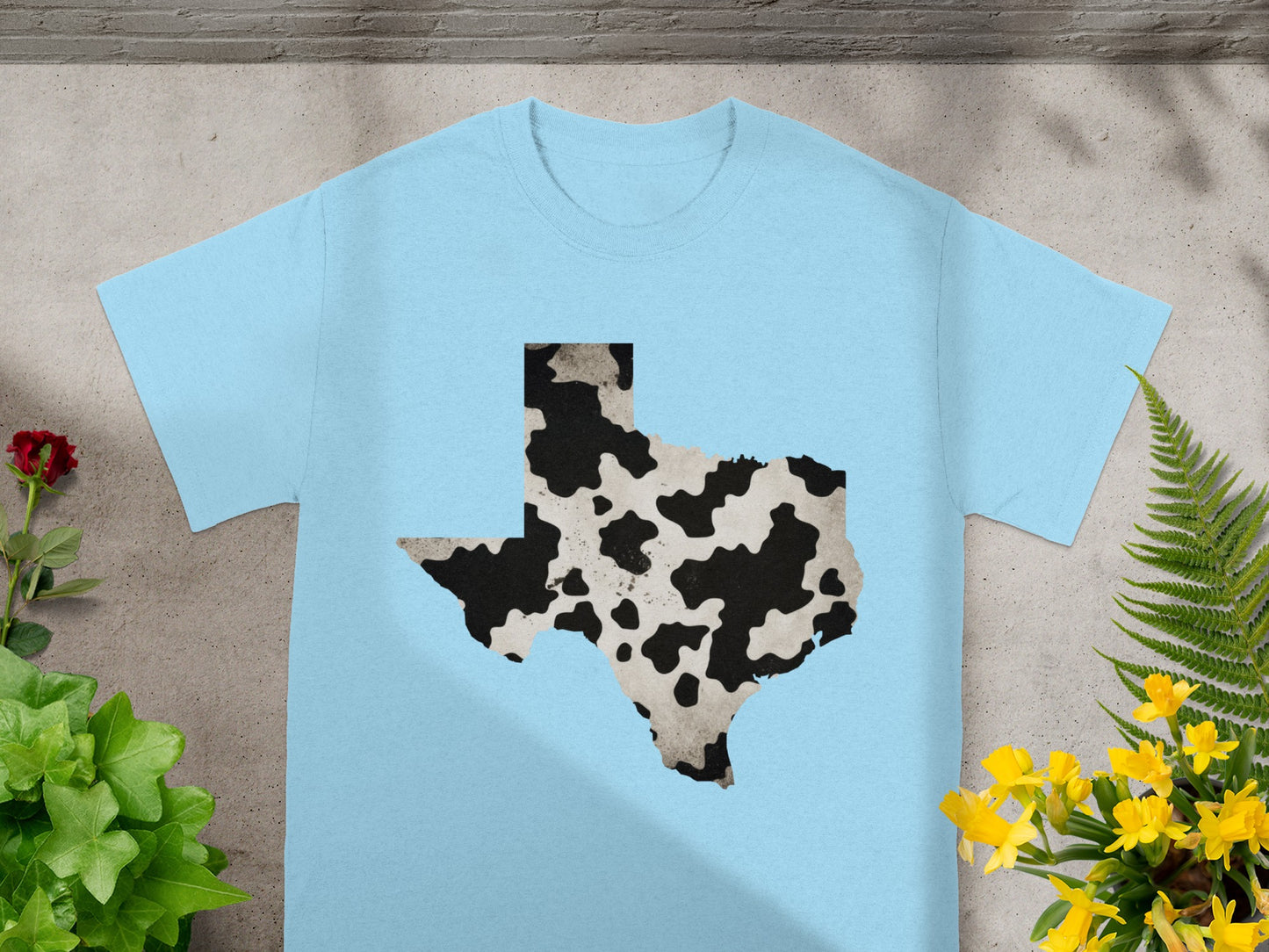 Light blue t-shirt with Texas shape in cow print pattern.
