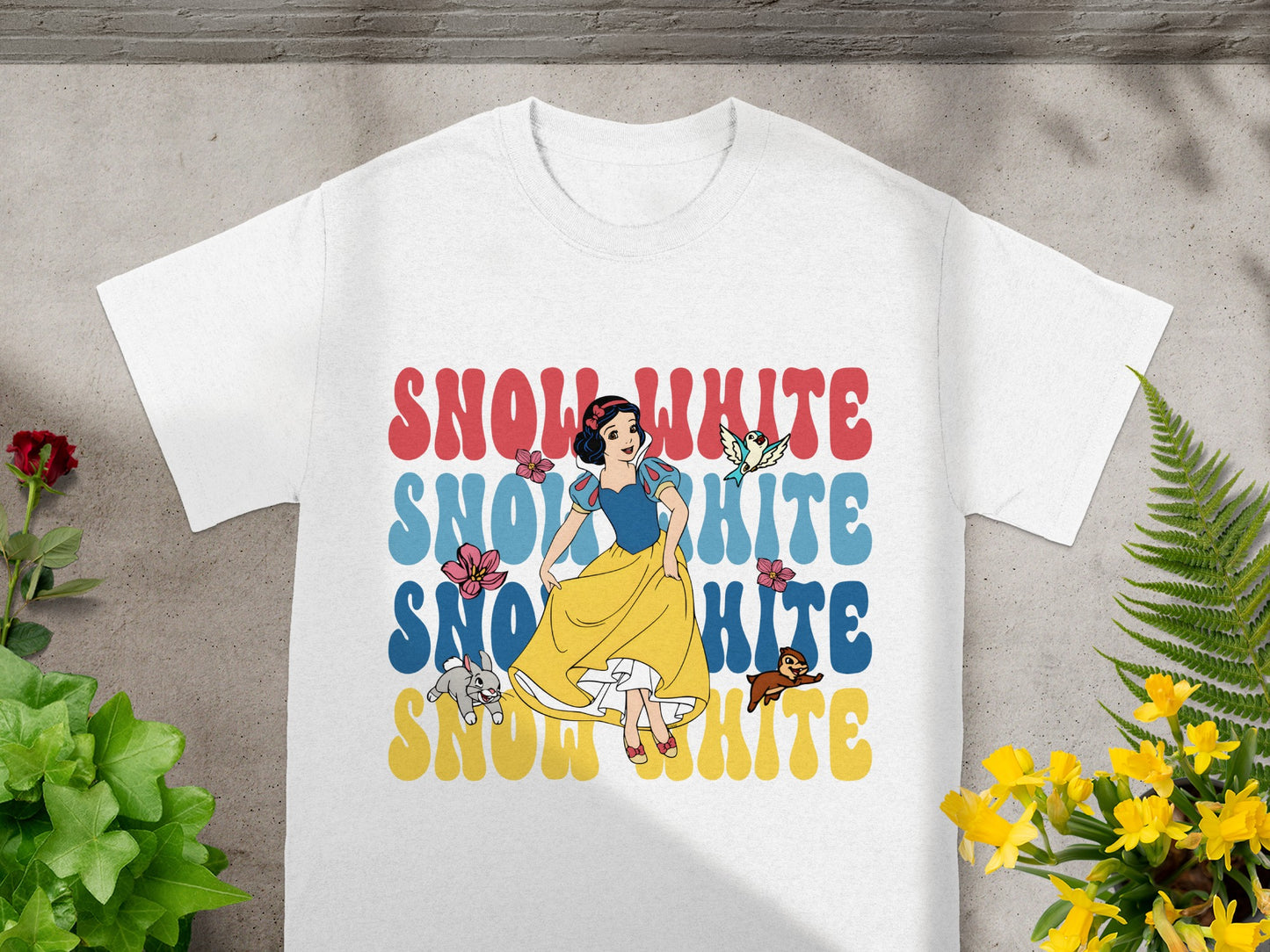 White t-shirt with Snow White graphic and text.