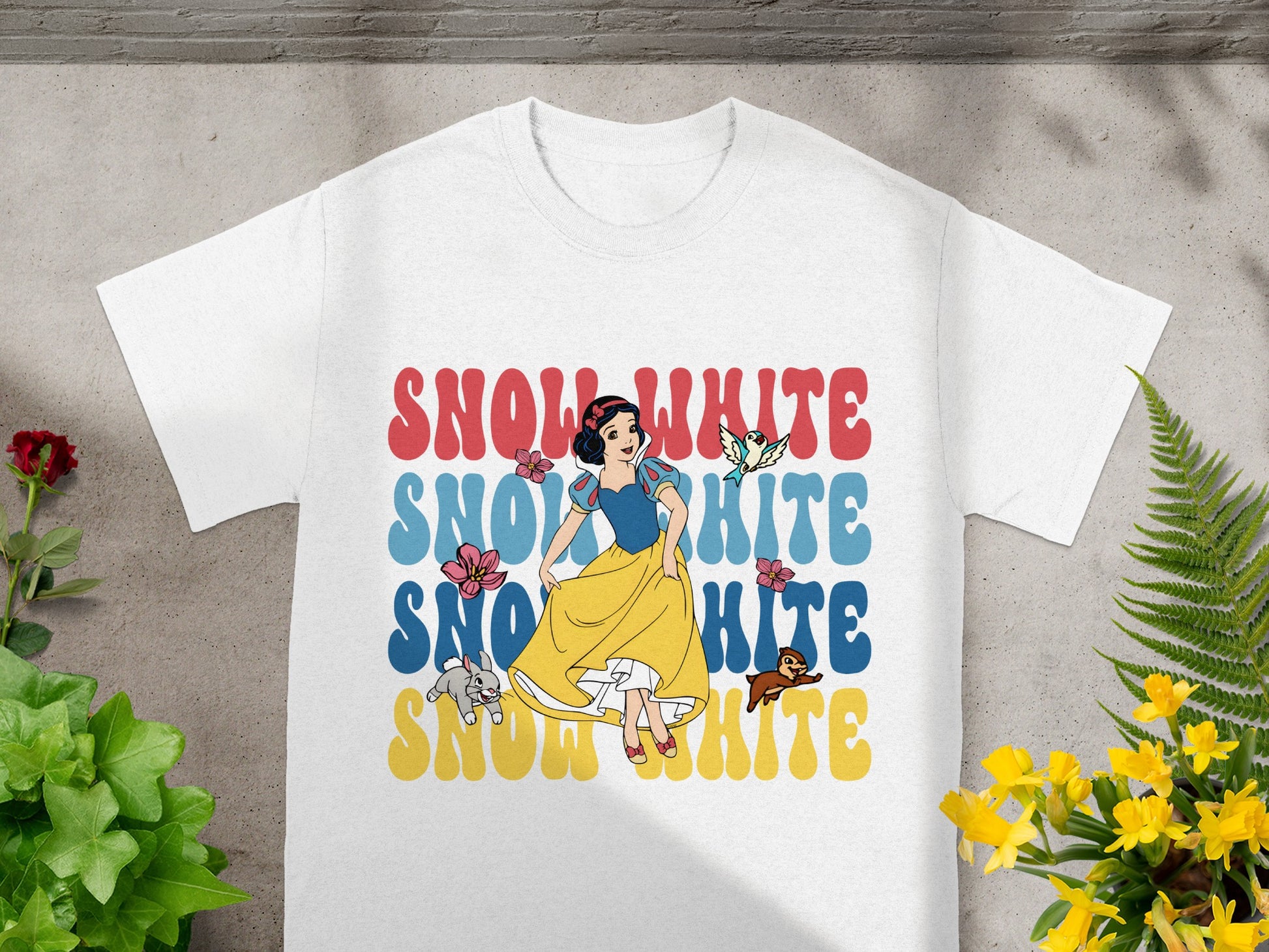 White t-shirt with Snow White graphic and text.