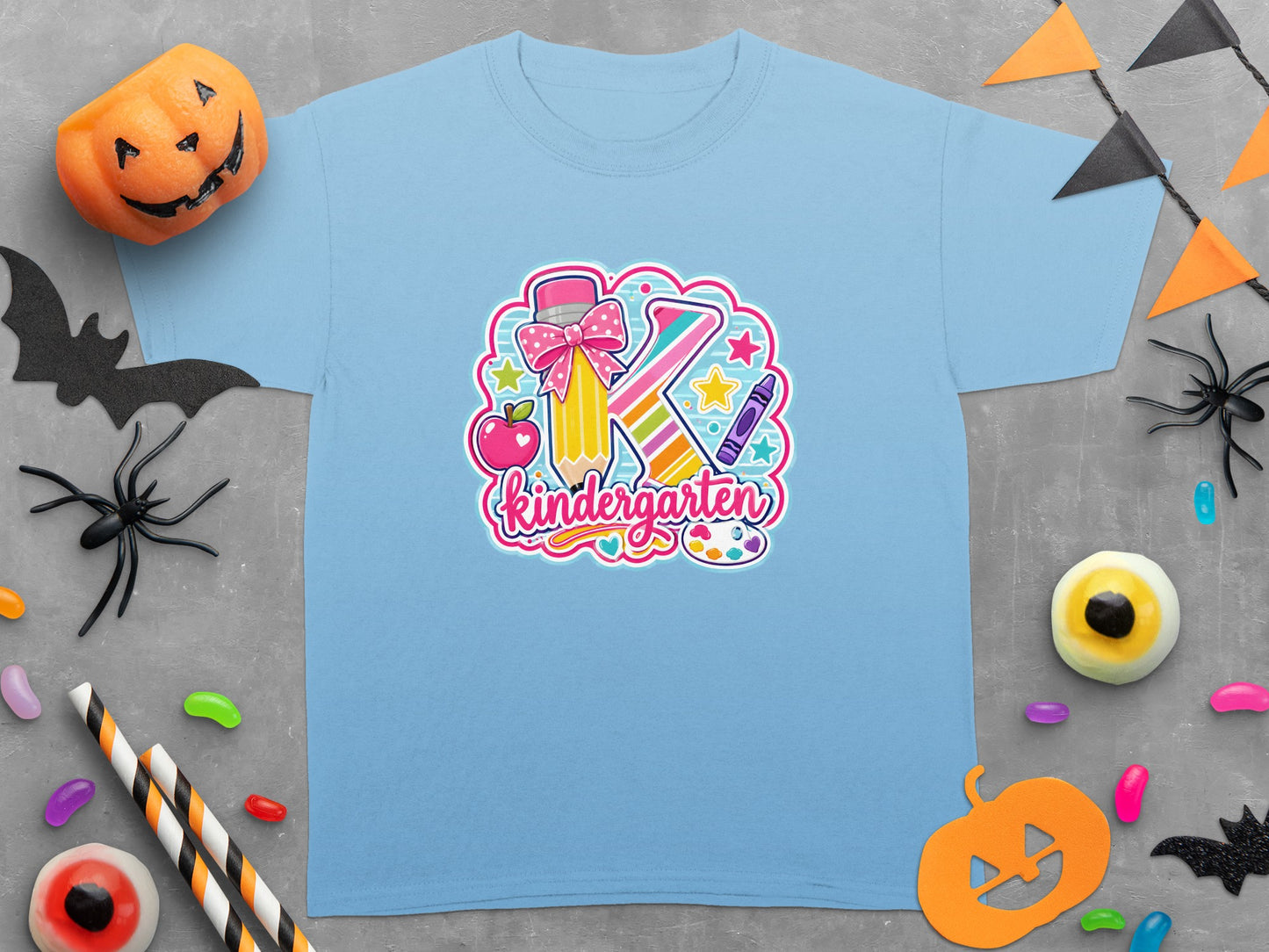 Light blue t-shirt with "Kindergarten" graphic featuring a large "K" with school supplies.