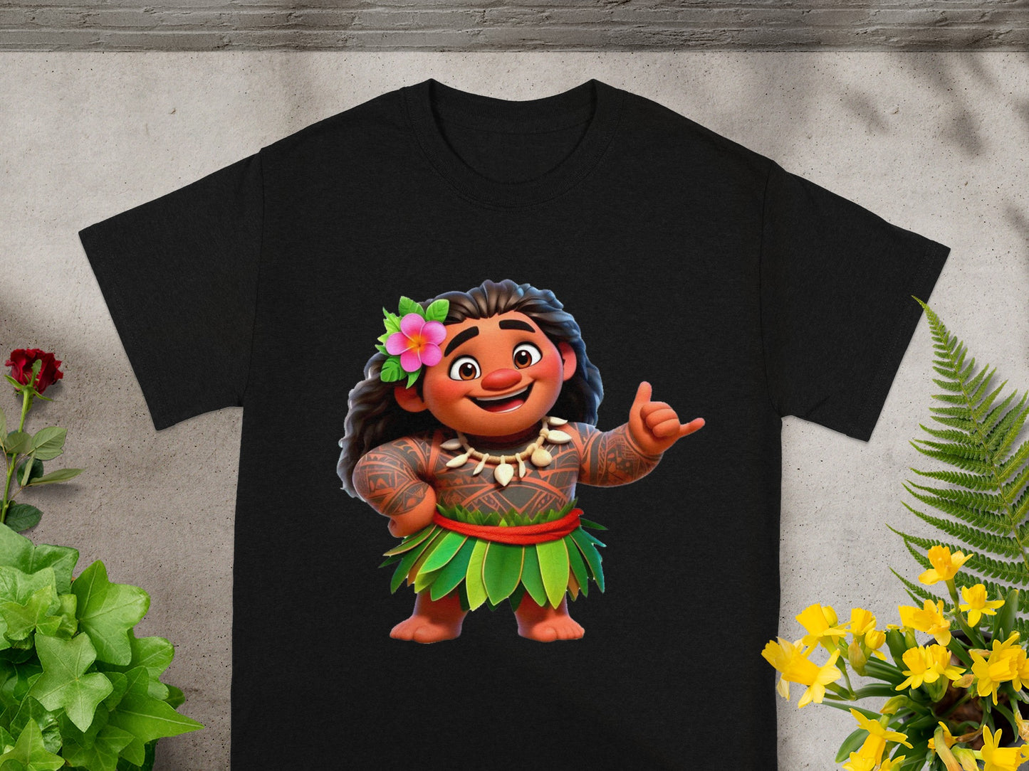 Black t-shirt featuring animated character Maui in a grass skirt and lei, giving a shaka sign.