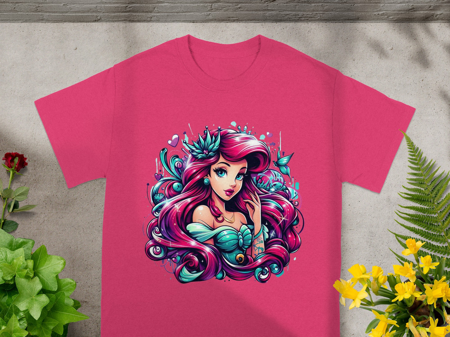Pink t-shirt with vibrant illustration of a mermaid with flowing pink hair.