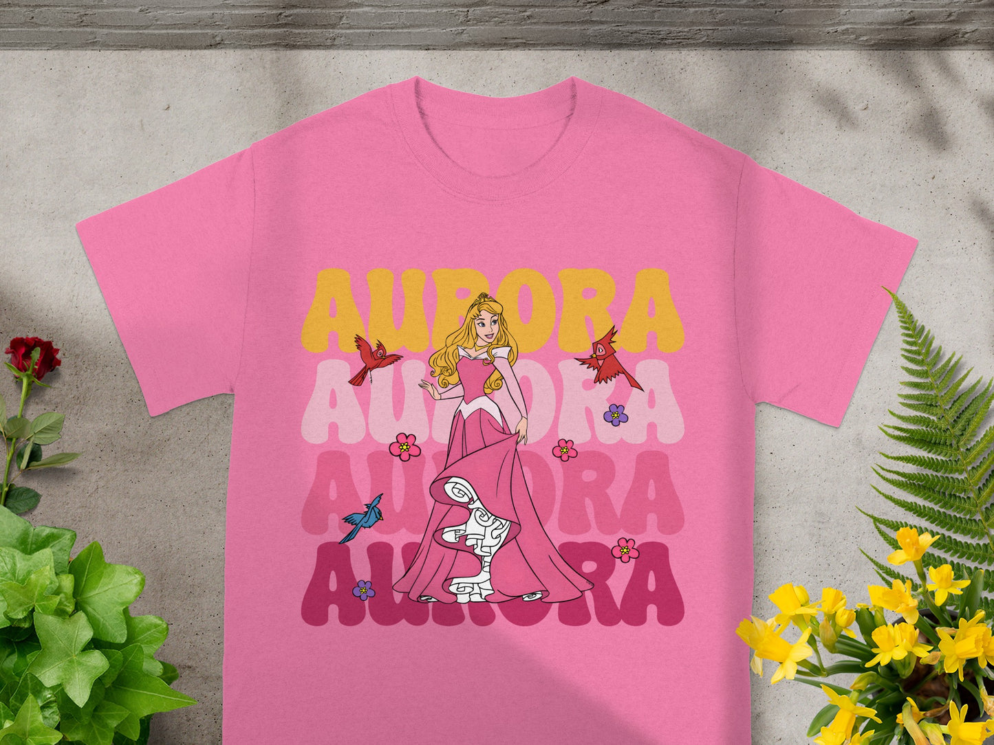 Pink t-shirt with Aurora, pink dress, flowers, and birds graphic.