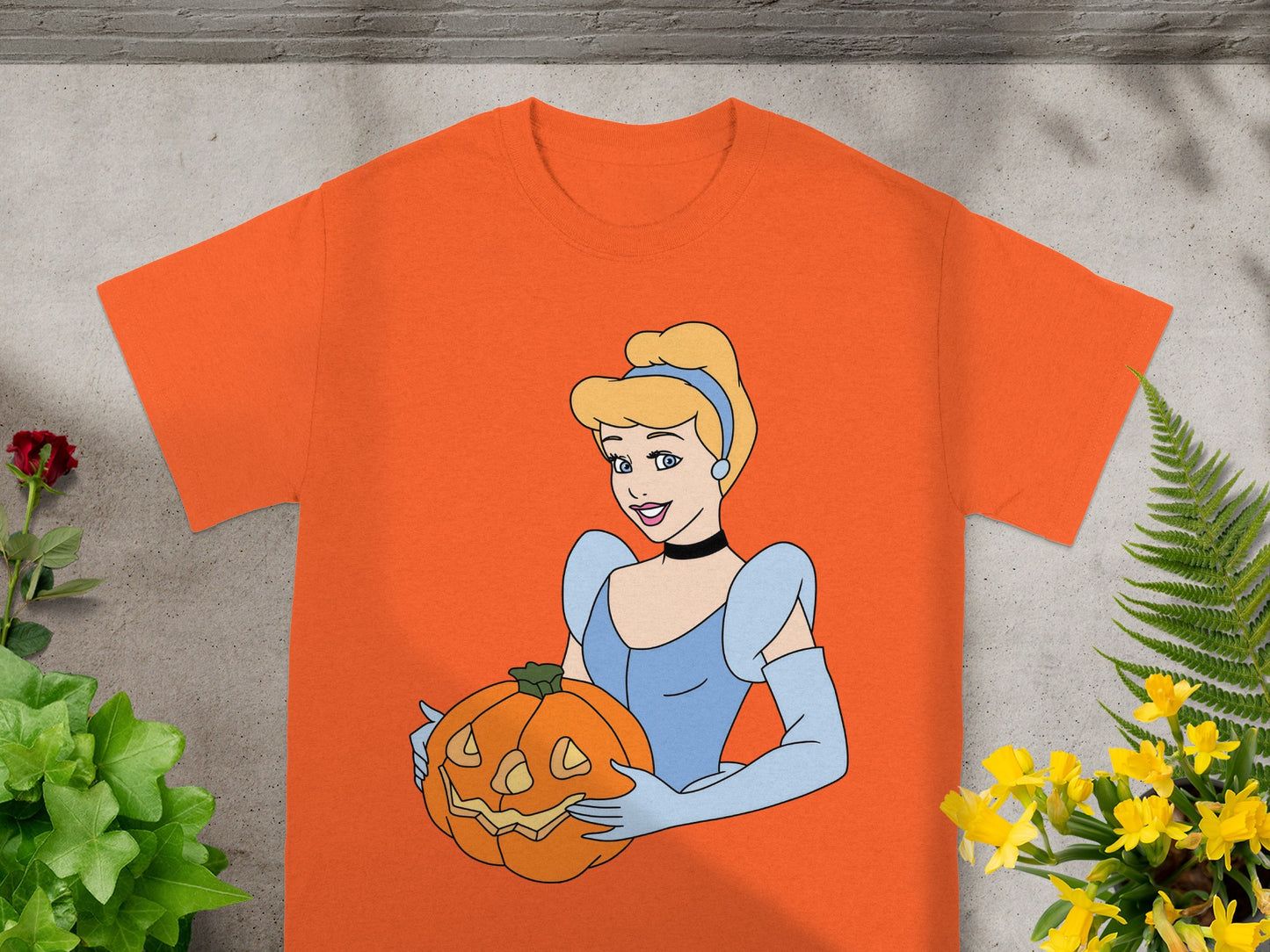 Orange t-shirt with Cinderella holding a jack-o'-lantern.