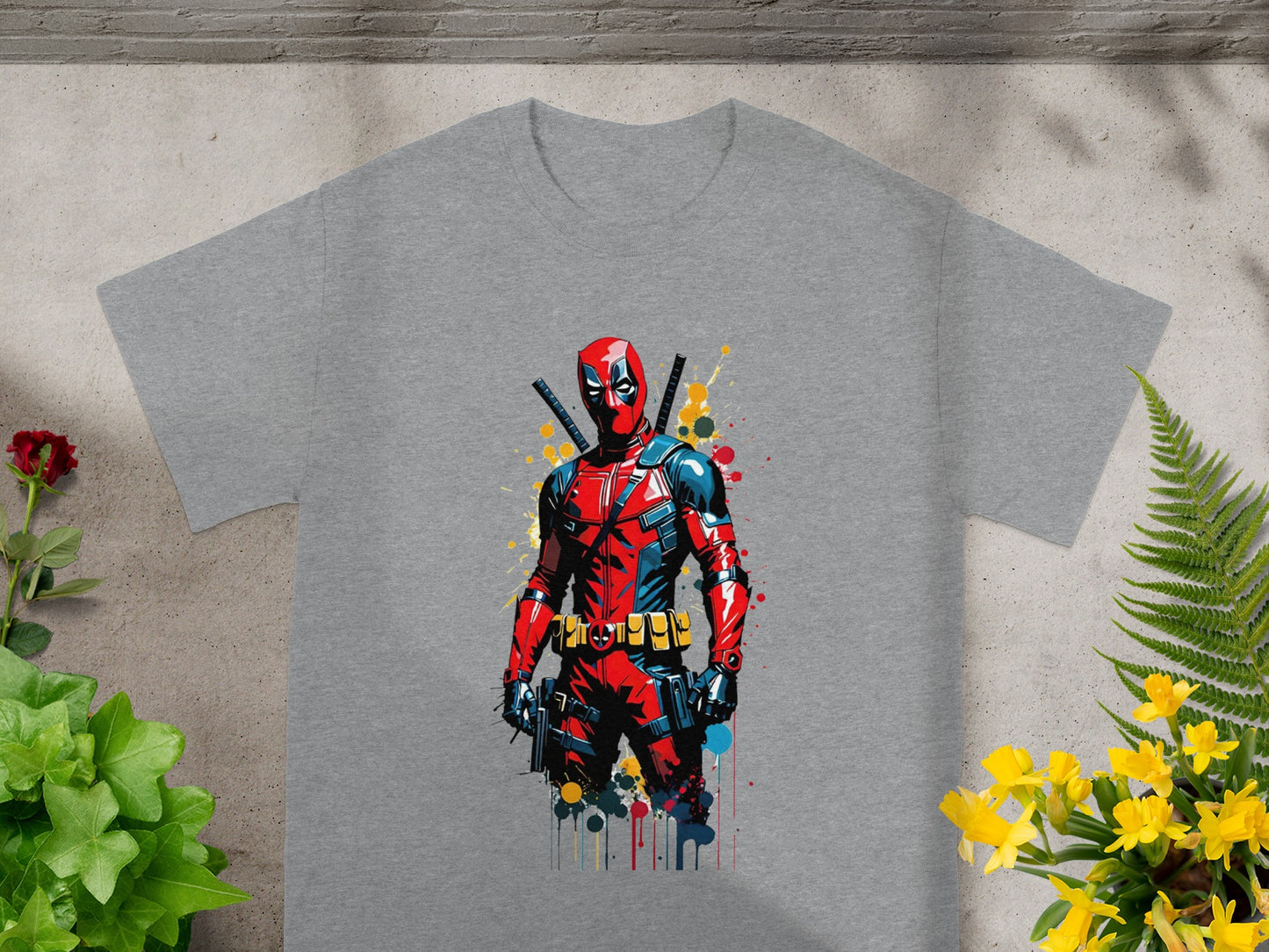 Gray t-shirt featuring Deadpool comic art with vibrant splashes of paint.