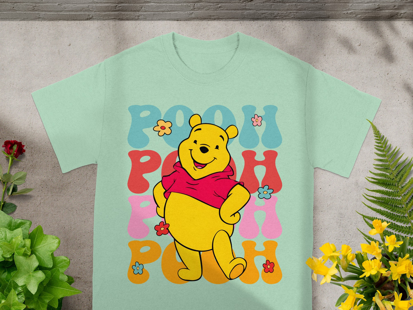 Winnie the Pooh graphic t-shirt with colorful "Pooh" text.