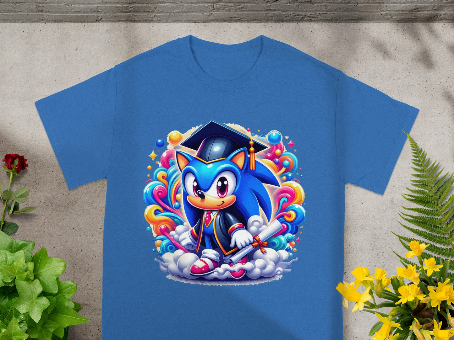 Sonic the Hedgehog in graduation cap and gown holding diploma, on blue t-shirt.
