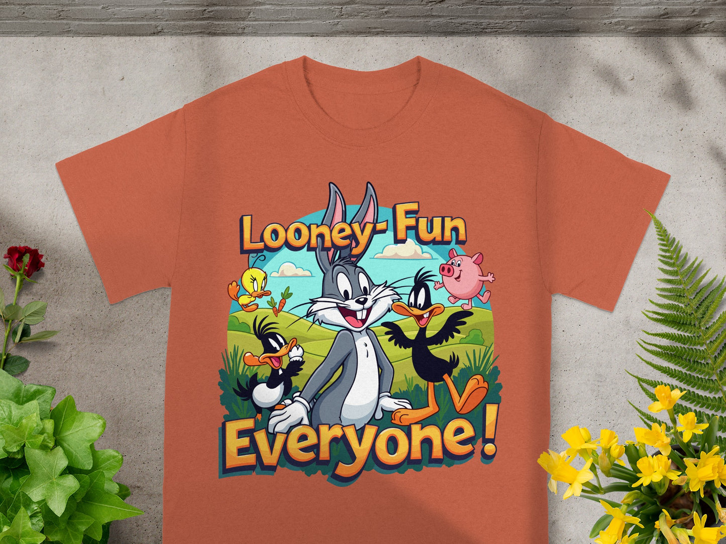 Looney Tunes characters Bugs Bunny, Daffy Duck, Porky Pig, and Tweety Bird on an orange t-shirt.