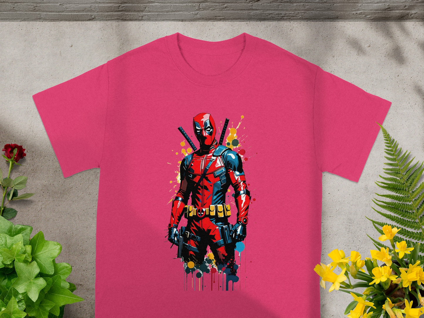 Deadpool graphic on pink t-shirt with splatter paint accents.