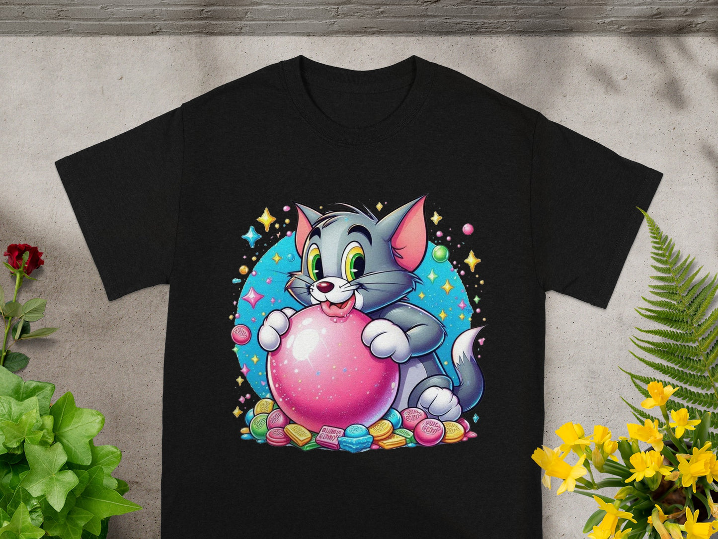 Black t-shirt with cartoon Tom cat holding a pink gumball surrounded by colorful candies.
