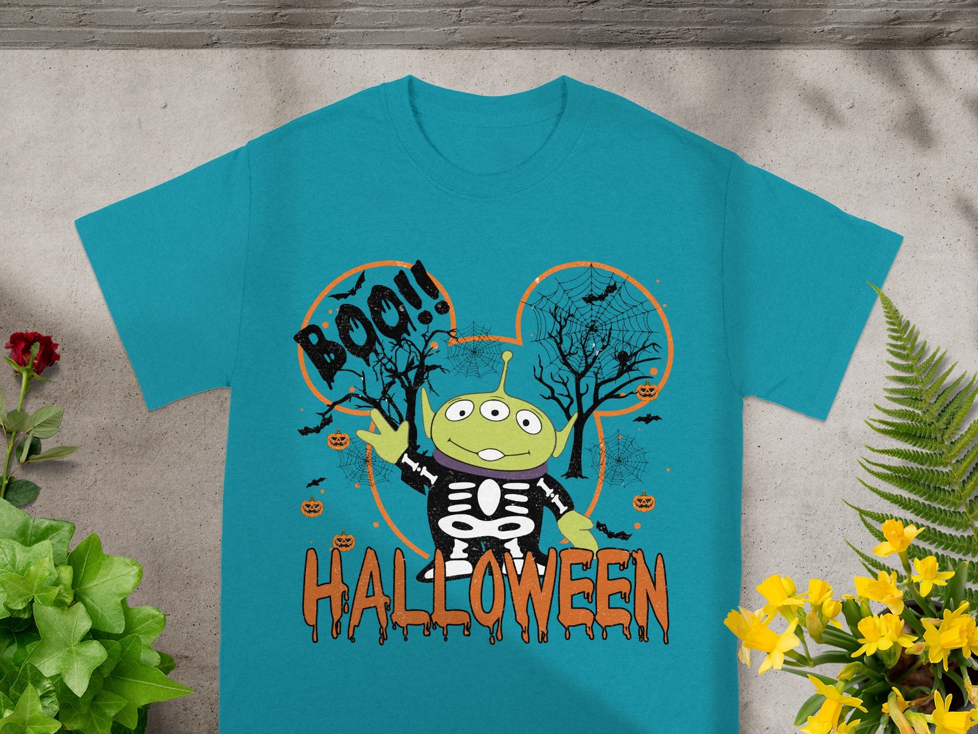 Toy Story alien in skeleton costume on Halloween themed shirt with "BOO!!" and "HALLOWEEN".