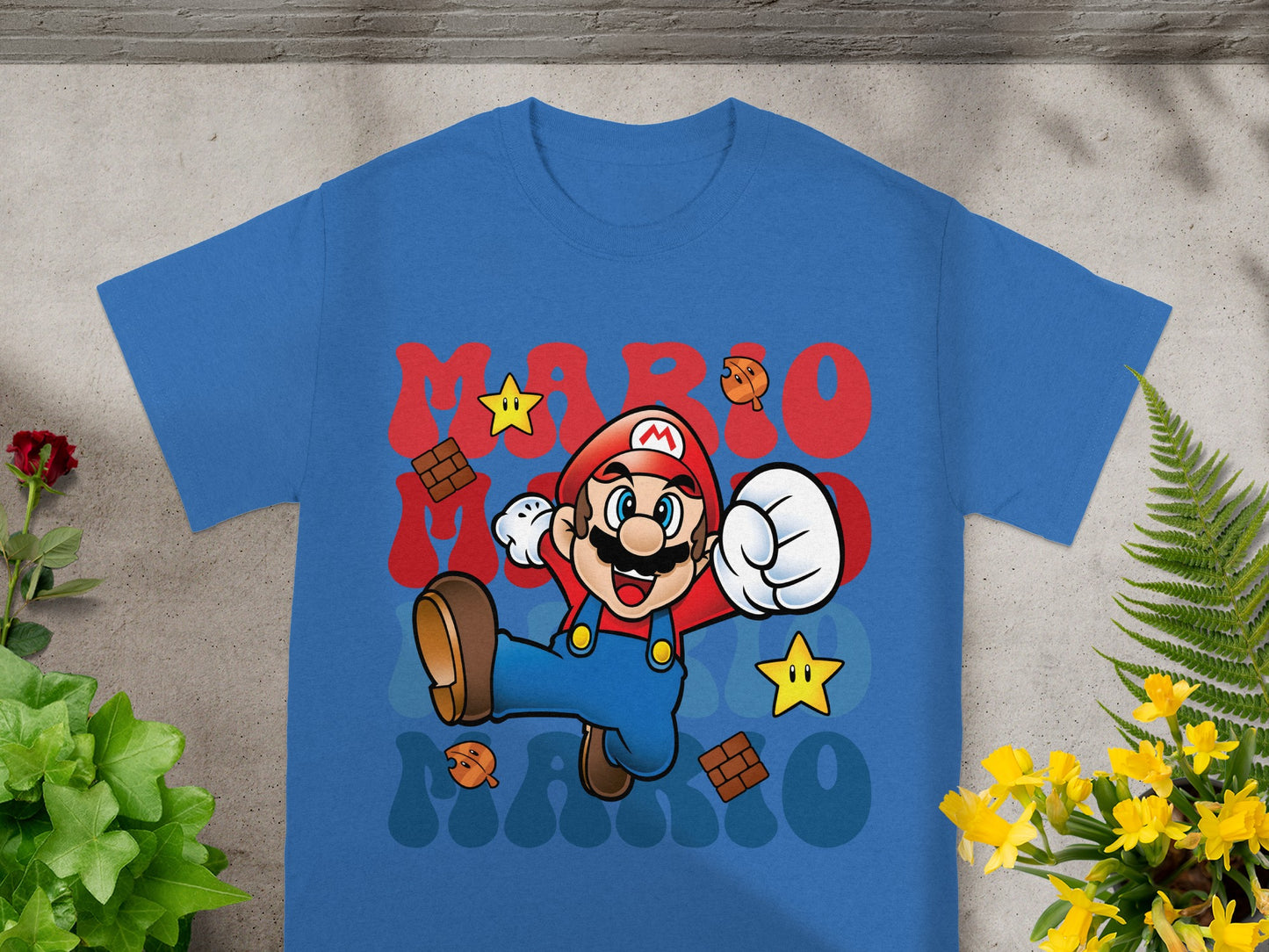 Blue t-shirt with cartoon Mario, stars, and "Mario" text.