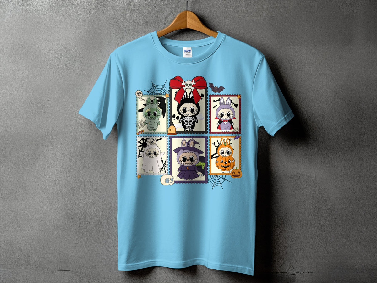 Light blue t-shirt with a grid of six Halloween-themed cartoon characters.