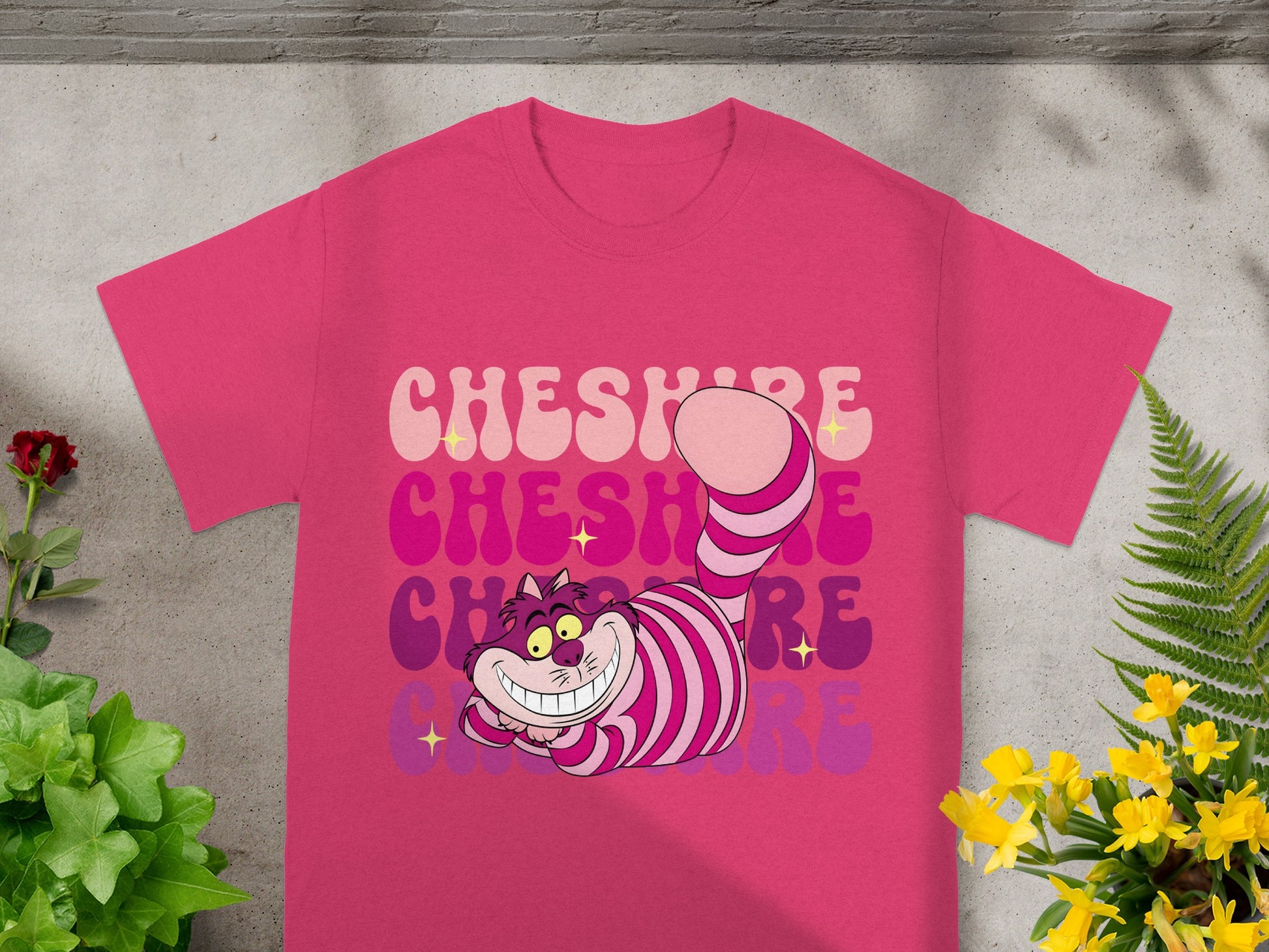 Pink t-shirt with "Cheshire" repeated in colorful retro lettering.
