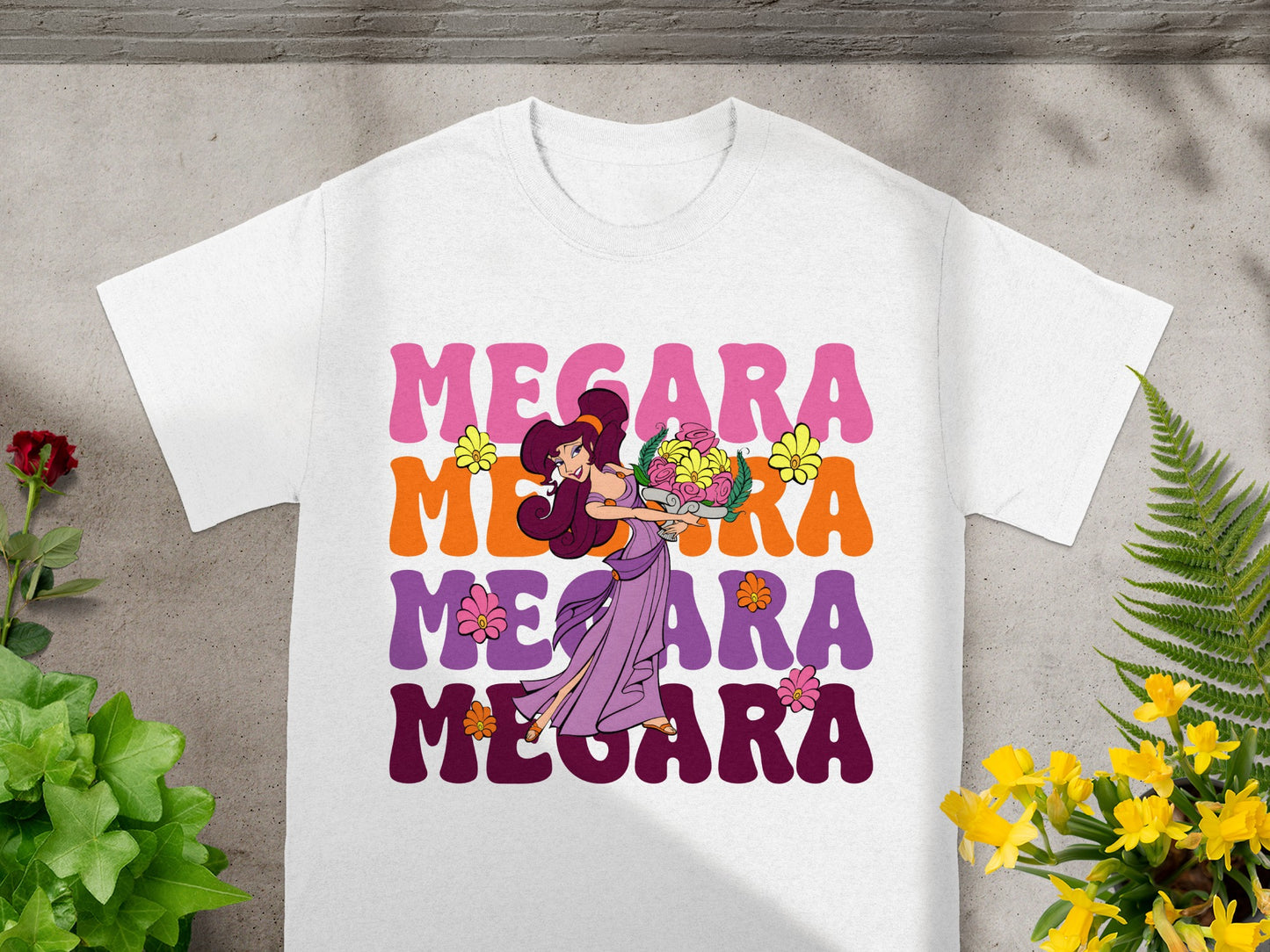 Megara graphic on white t-shirt with colorful text below.