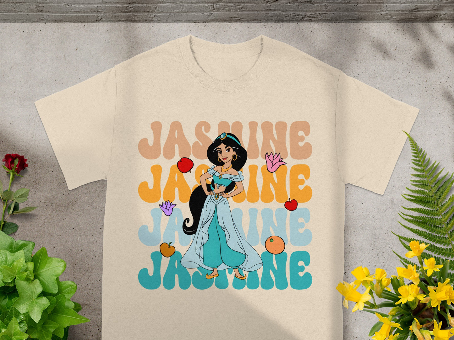 Light tan t-shirt with colorful "JASMINE" text and Disney's Jasmine.