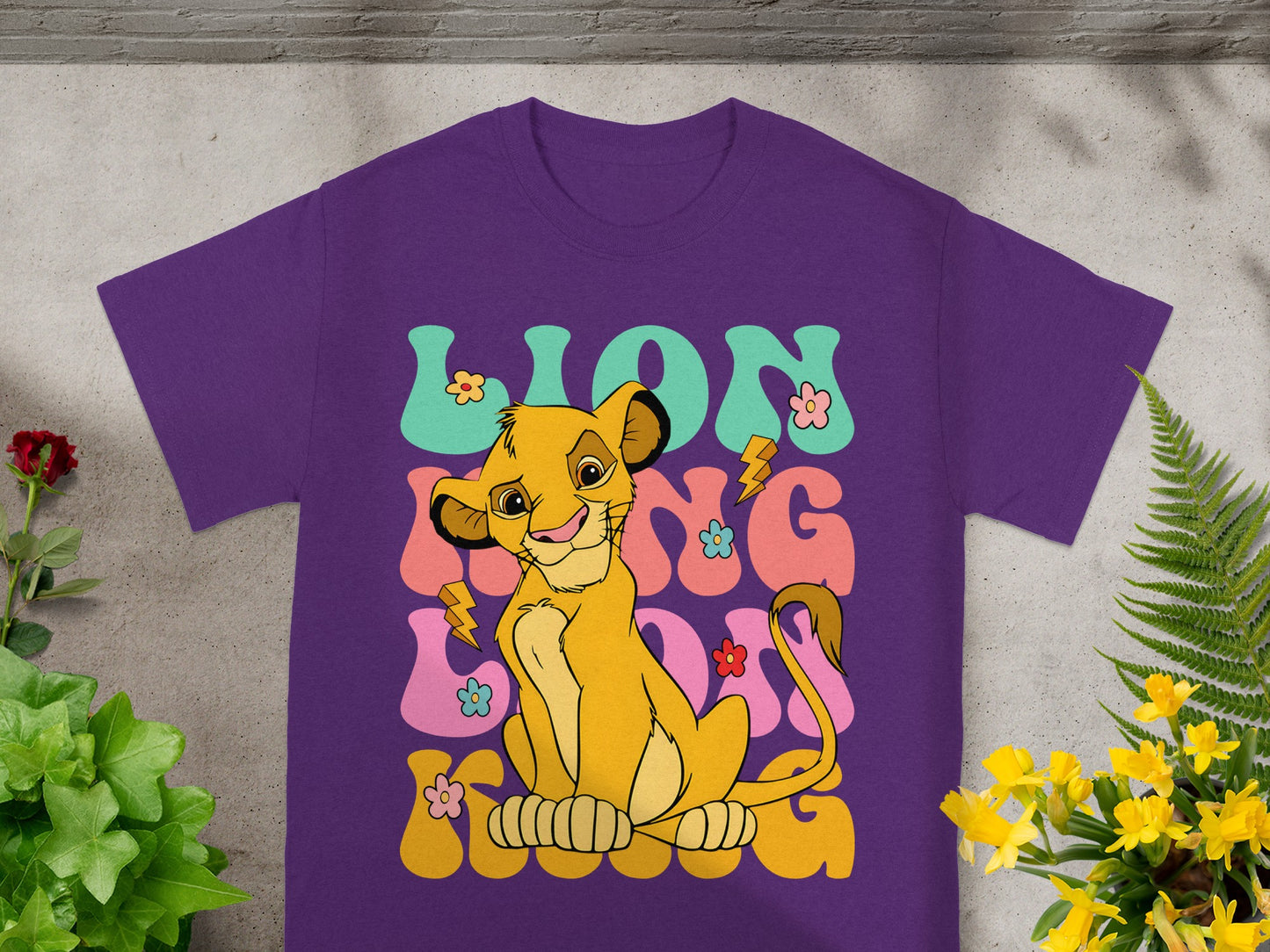 Purple t-shirt with Simba from The Lion King and "Lion King" text.