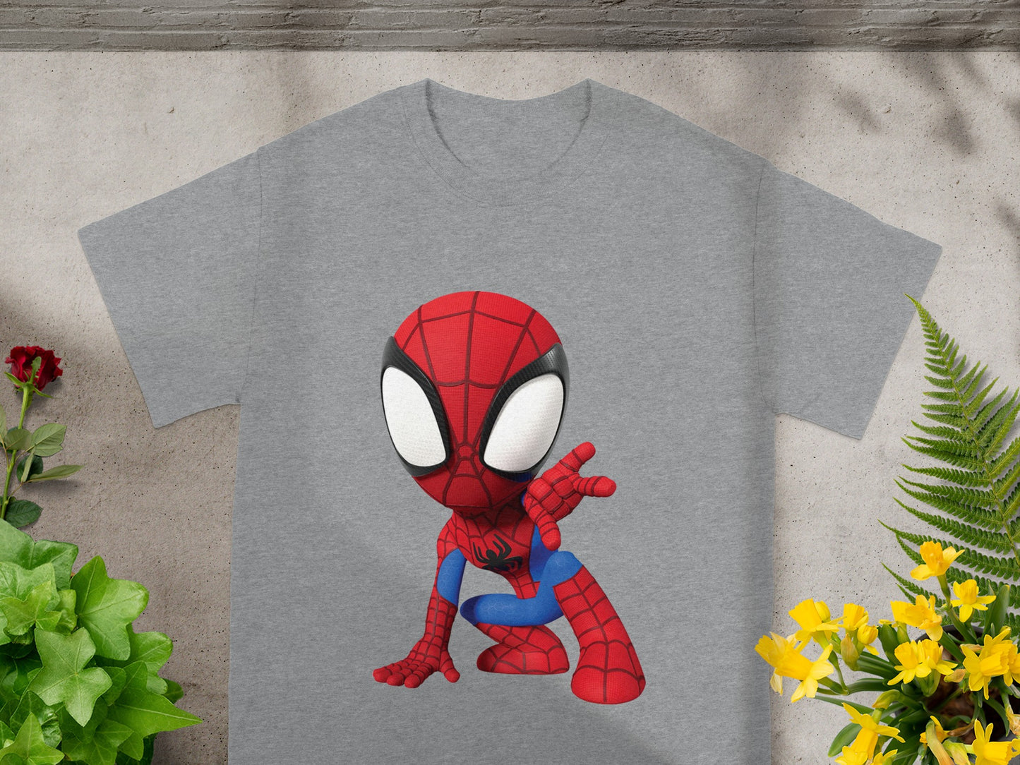 Grey t-shirt with a cartoon Spiderman graphic in crouched pose.