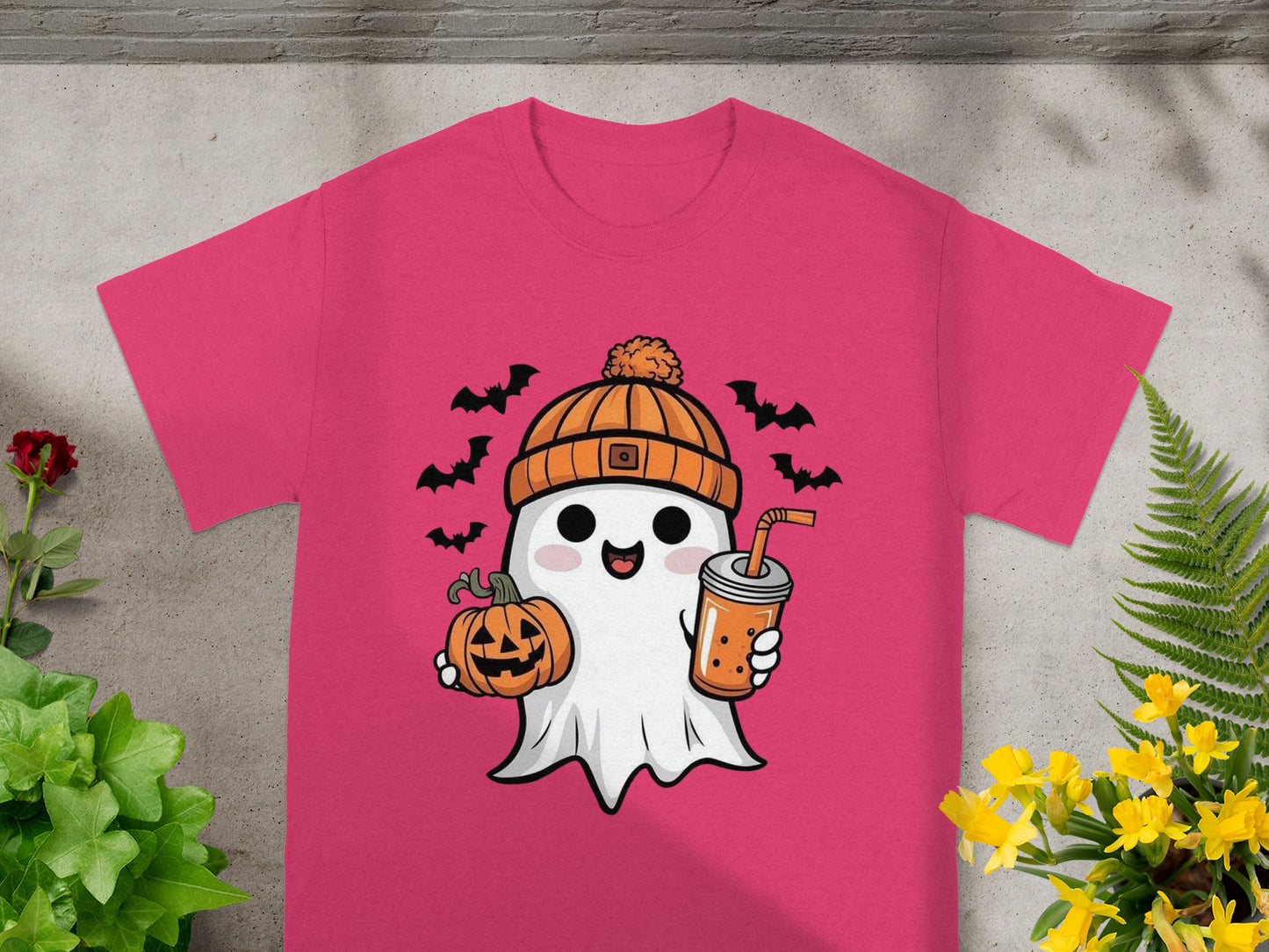 Pink t-shirt with a kawaii ghost holding a pumpkin and bubble tea, surrounded by bats.