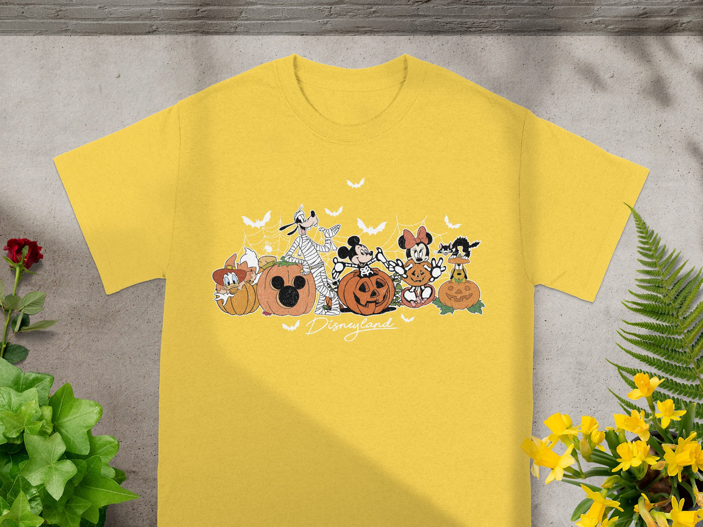 Yellow t-shirt with Halloween Disney characters and Disneyland text.