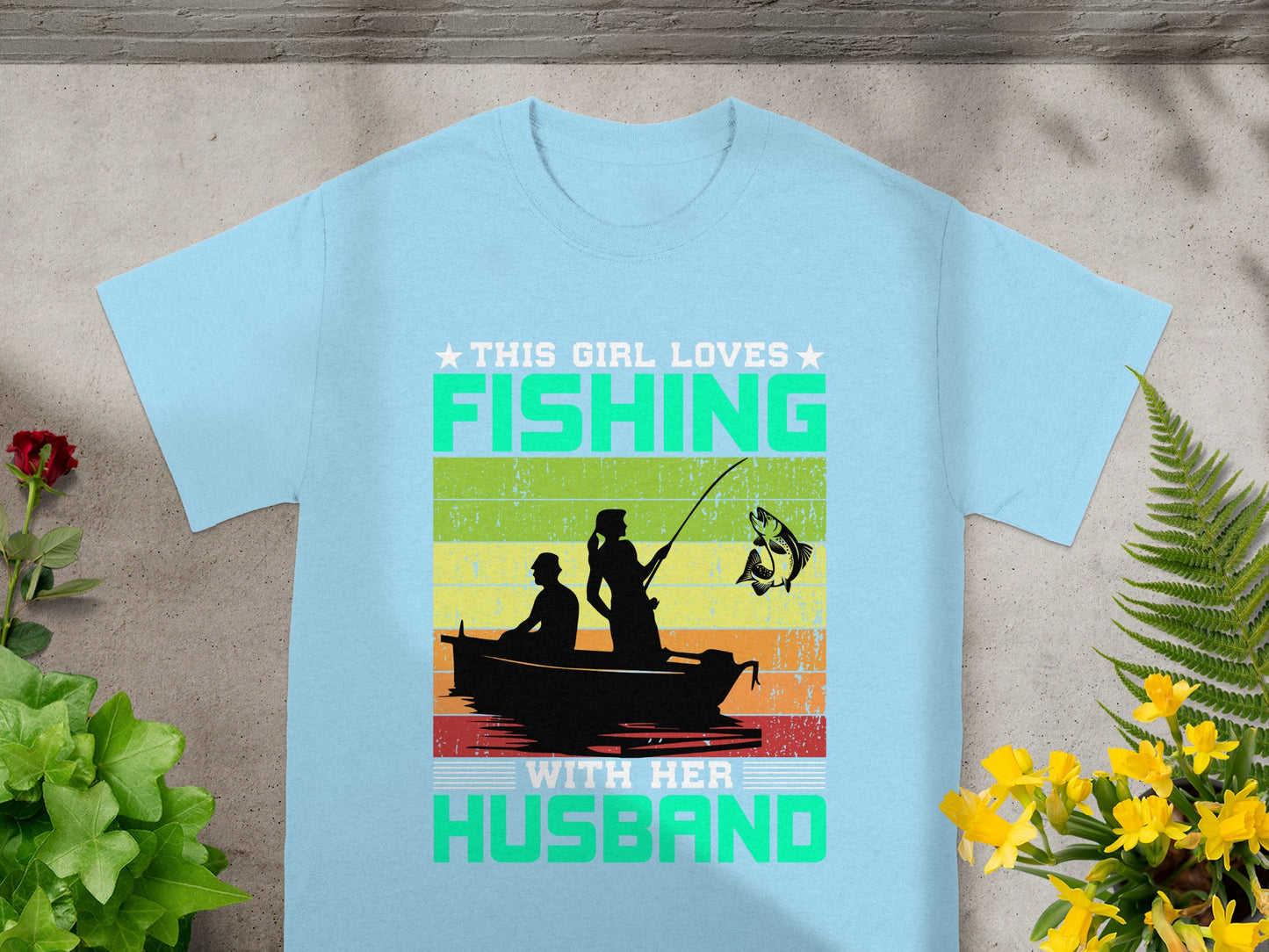 This girl loves fishing with her husband graphic on a light blue t-shirt.