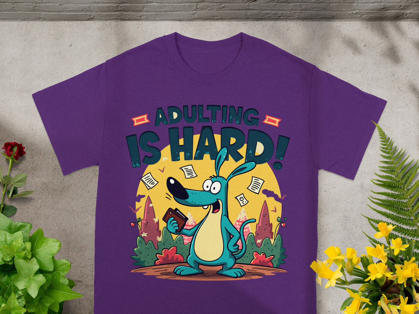 Purple t-shirt with "Adulting Is Hard!" text and cartoon dog holding wallet.