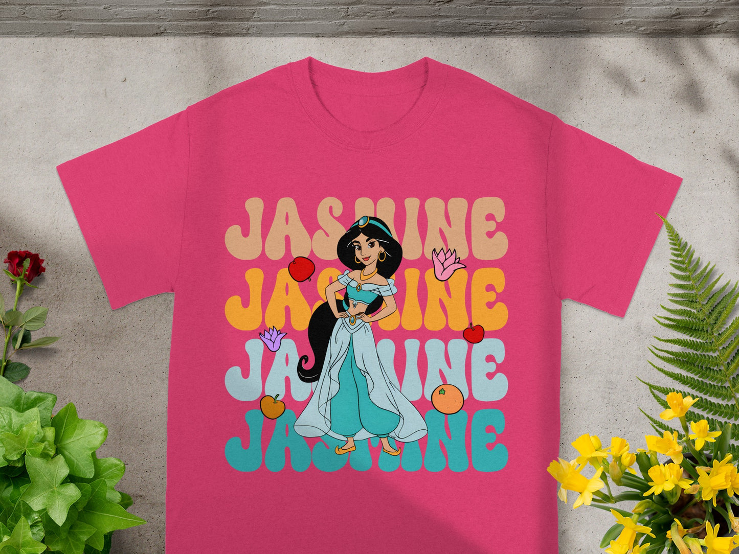 Pink t-shirt with Jasmine in a flowing dress and colorful text.