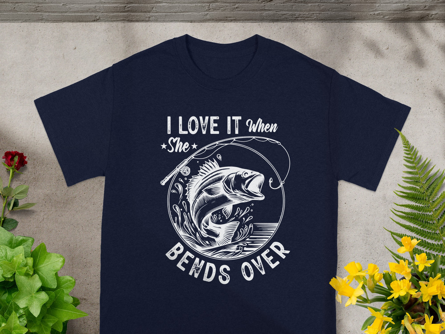 Navy t-shirt with white graphic "I LOVE IT when She BENDS OVER" and a fish.