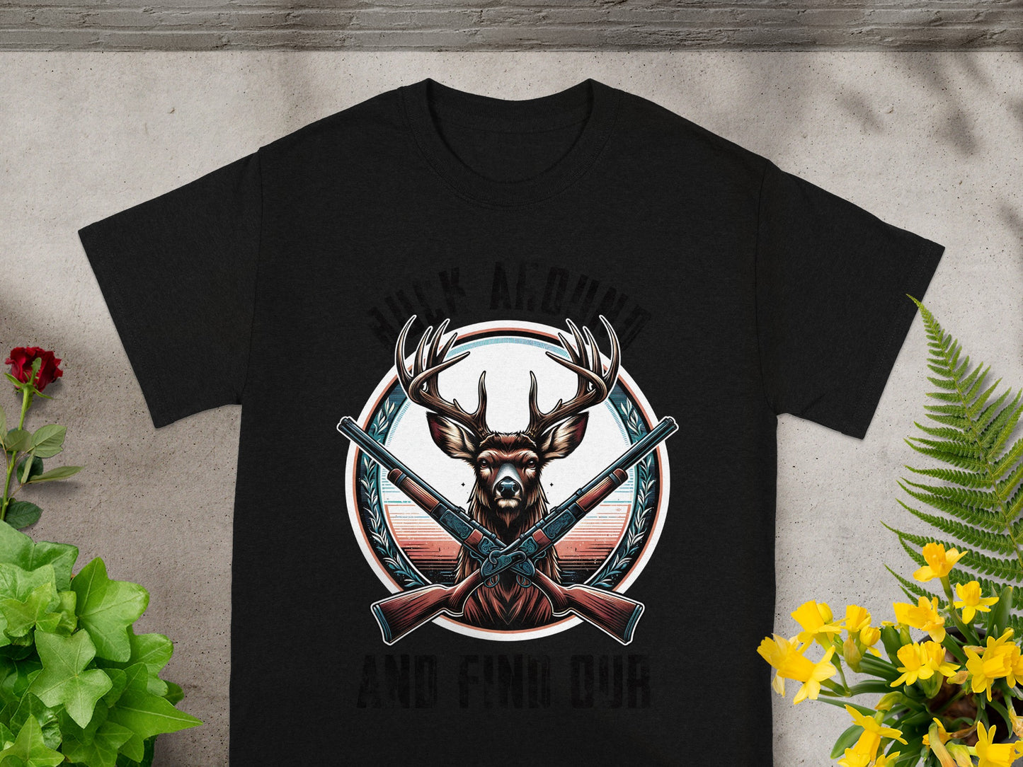 Black t-shirt with deer, crossed shotguns, and text "HUCK AROUND AND FIND OUR".
