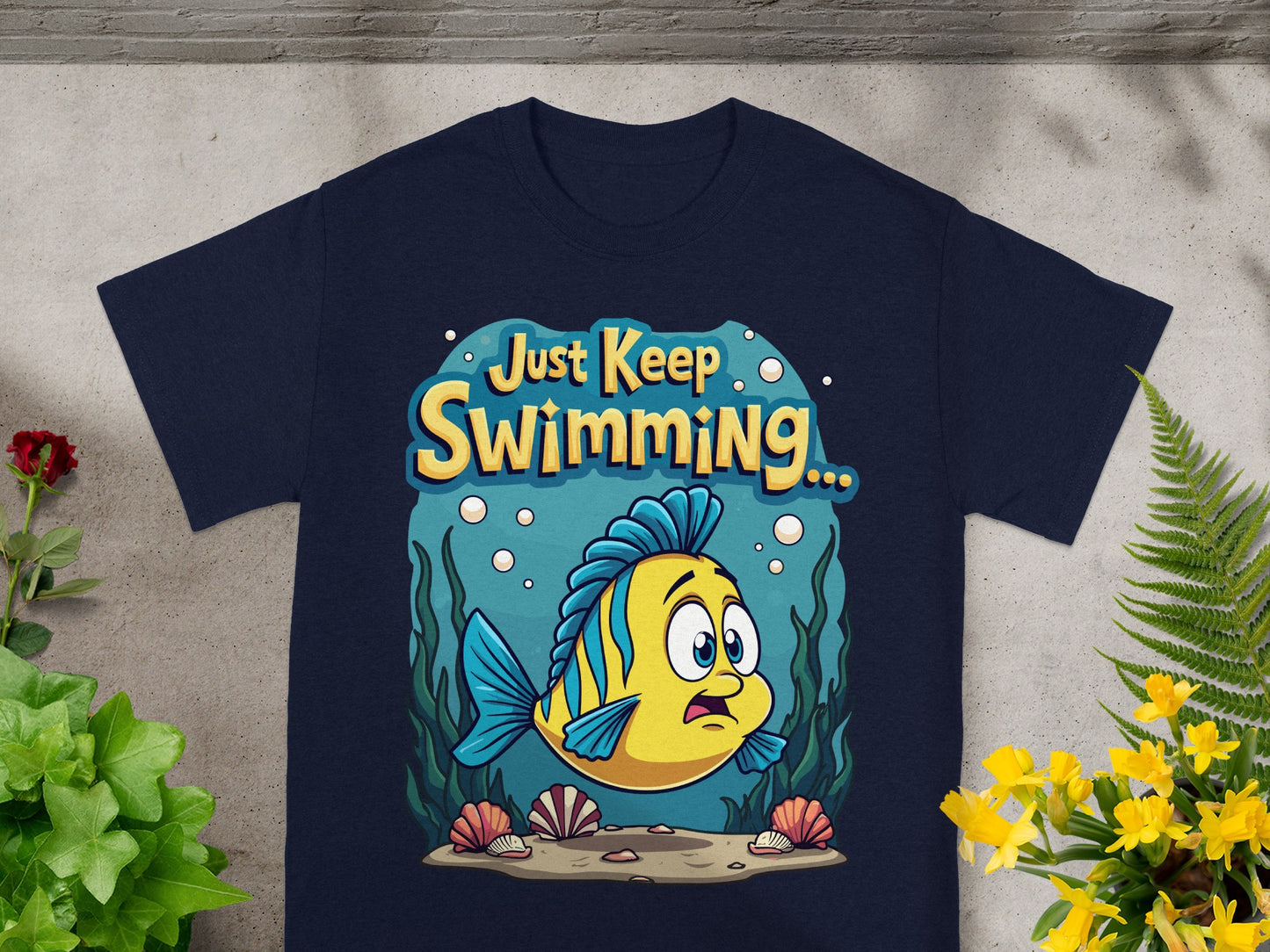 Blue t-shirt with yellow fish and "Just Keep Swimming..." text.