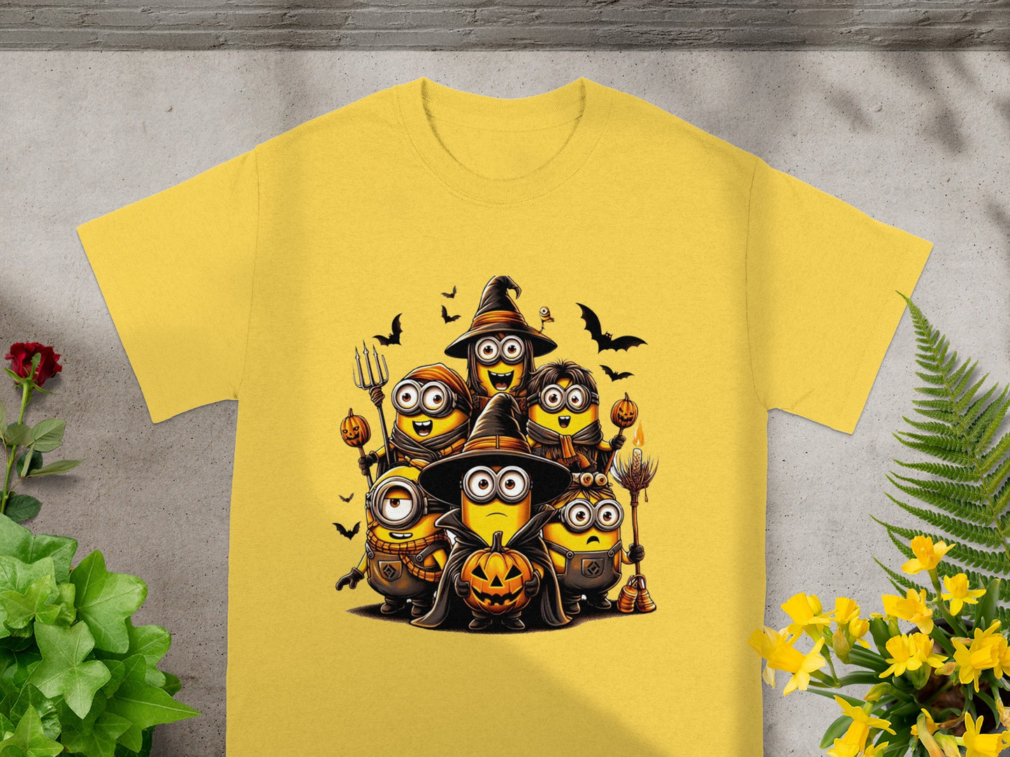 Yellow t-shirt with a graphic of Minions dressed for Halloween with pumpkins.