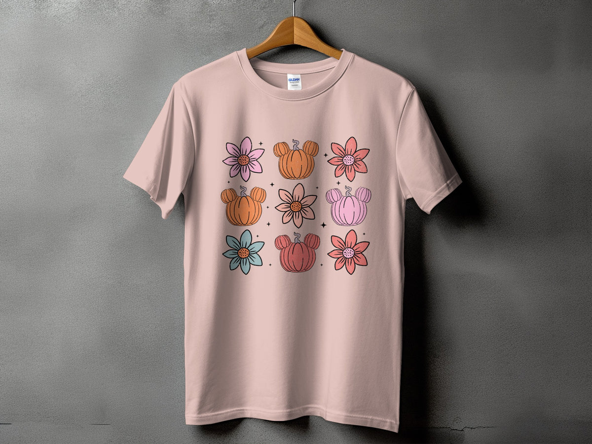 Pink t-shirt with a grid of flowers and pumpkins with mouse ears.